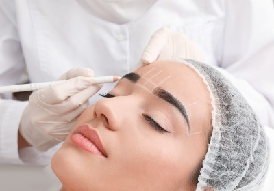 A beautiful woman receiving a permanent makeup treatment.