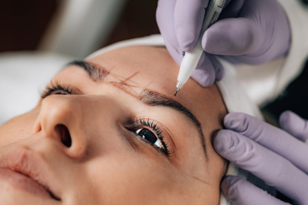 Close-up of Beautician Doing Permanent Brow Makeup