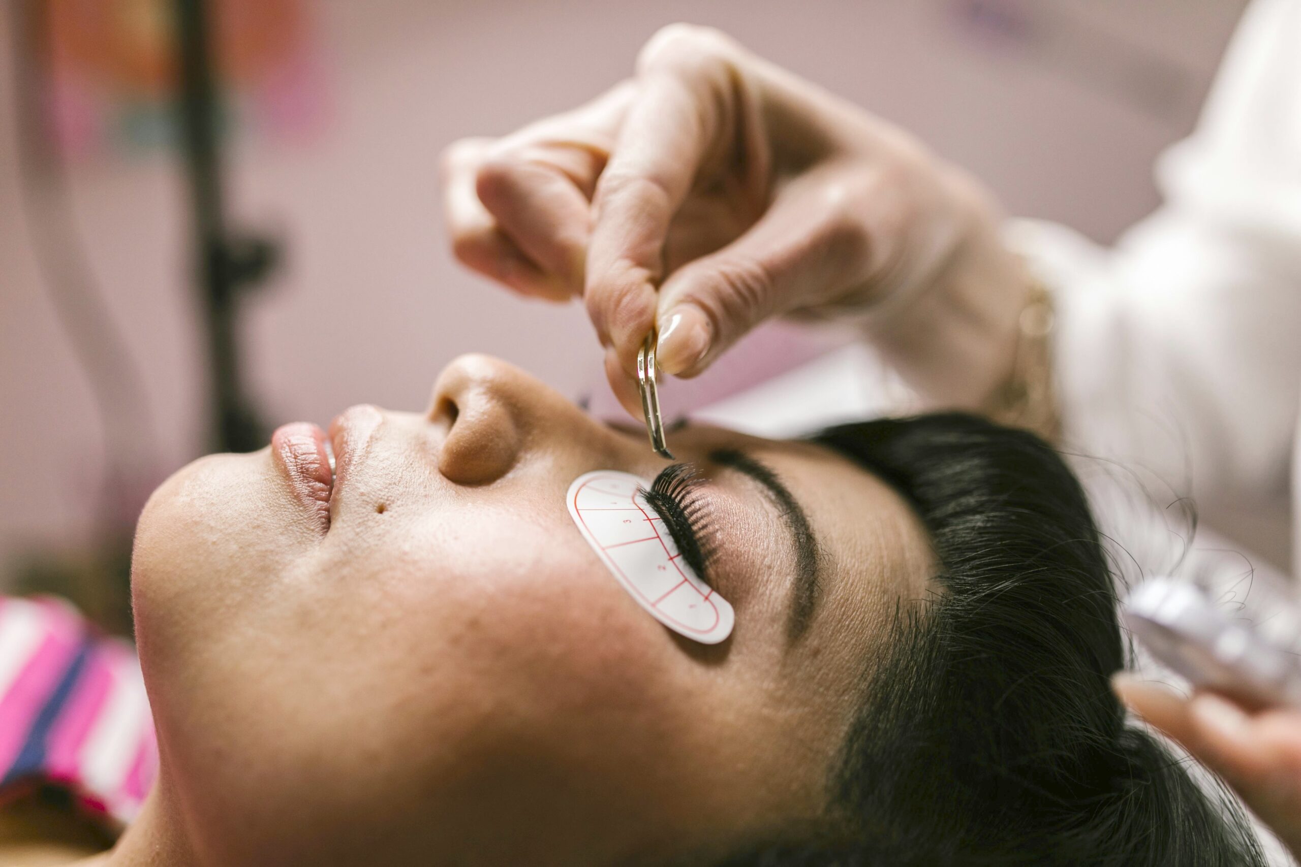 a waman receiving eyelash extension